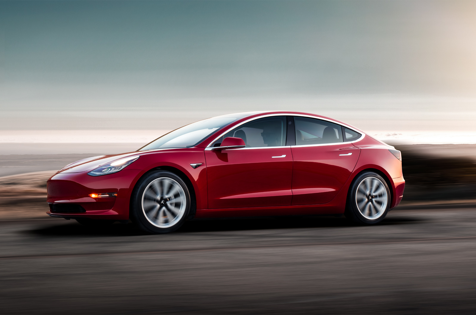 Model 3   red driving sunset